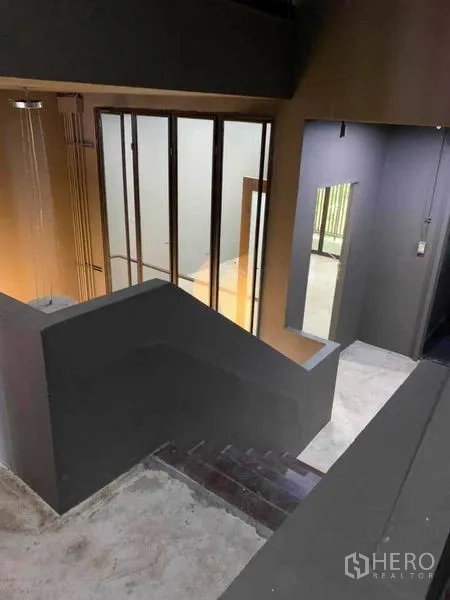Home Office for rent in Huai Khwang, Bangkok - Central staircase and atrium with full-height windows.