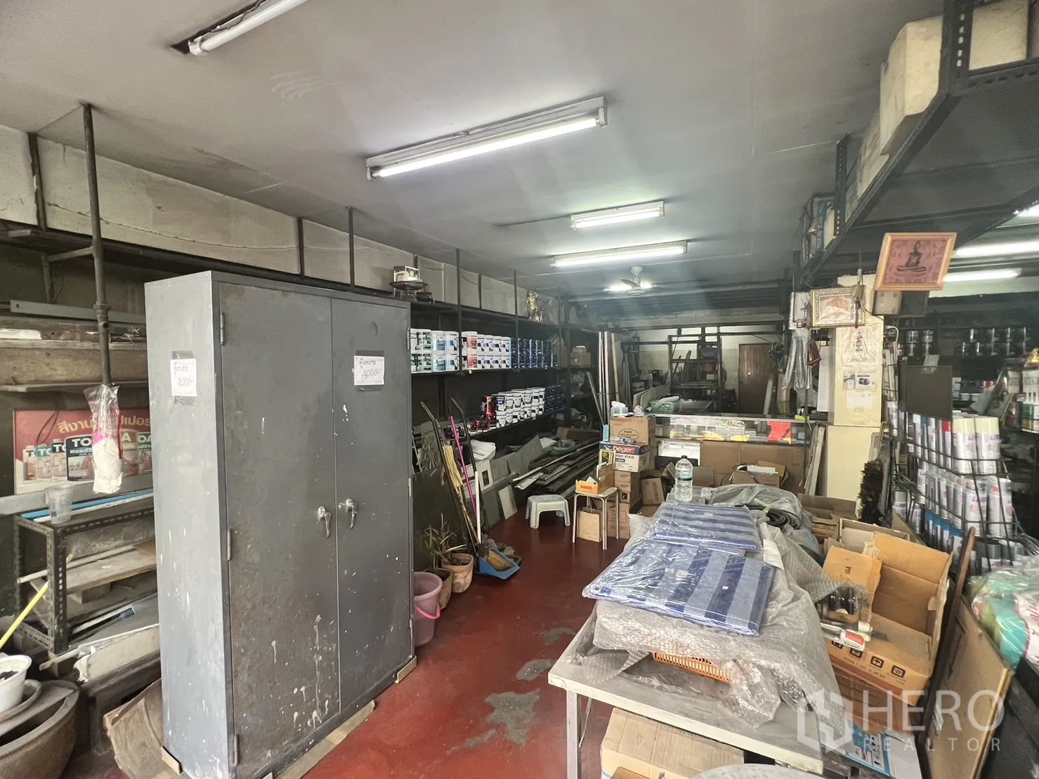Retail Space for rent in Watthana, Bangkok - Ground-floor retail shop with steel shelves, paint cans and storage under bright strip lights.