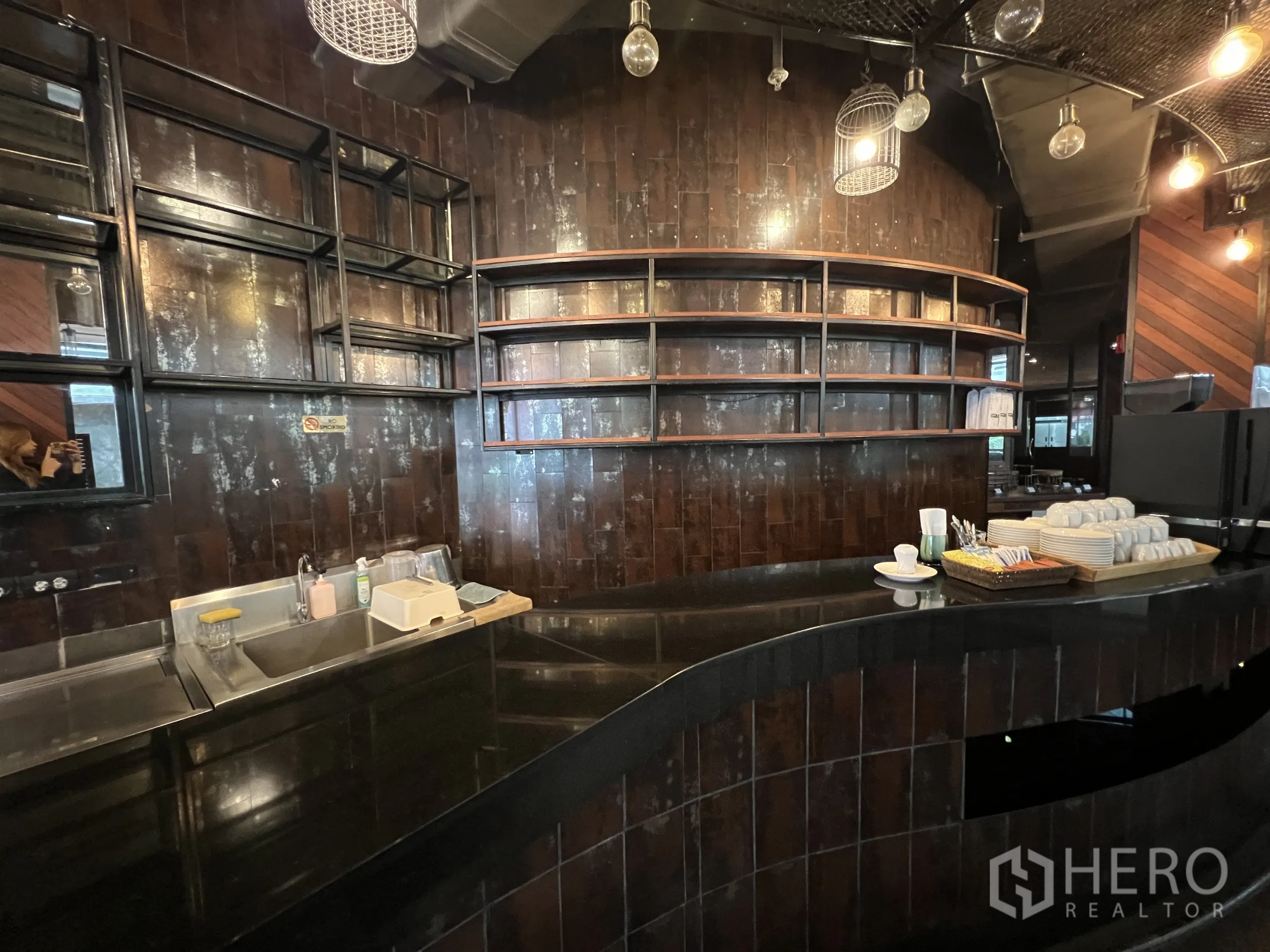 Retail Space for rent in Watthana, Bangkok - Back bar with stainless sink, curved shelving, and dark tiled finishes.