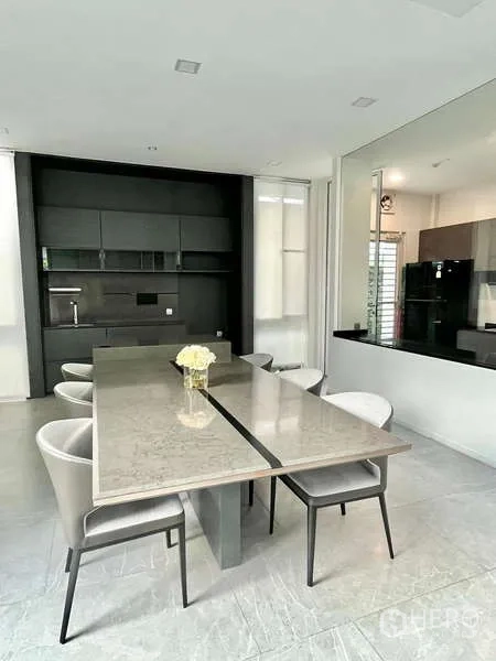 Detached House for rent or sale in Bang Phli, Samut Prakan - Dining space with a stone-top table, six chairs and dark built-in cabinetry.