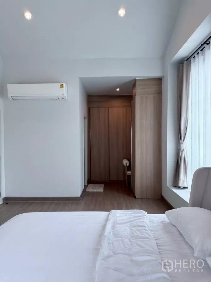 Detached House for rent in Lat Krabang, Bangkok - Master bedroom view with air-conditioning and large picture window.