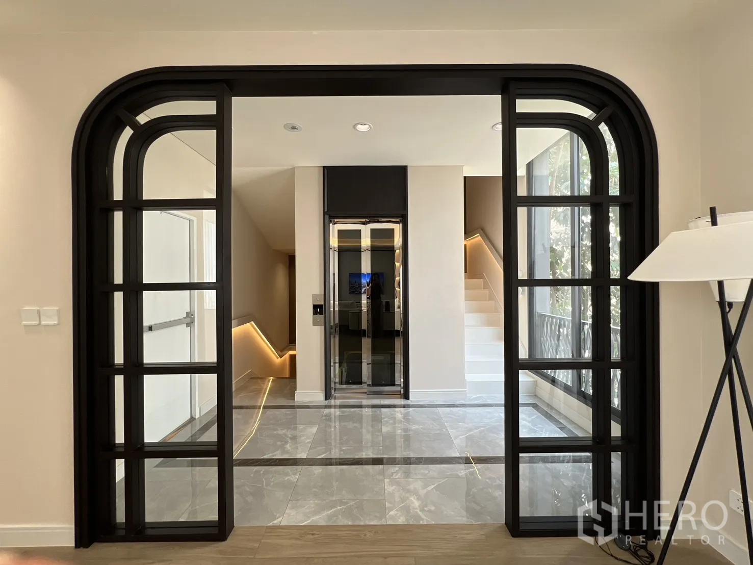 Semi-detached House for sale in Yan Nawa, Bangkok - Black-framed double doors revealing the lift lobby and stairway.