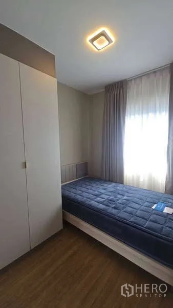 Townhouse for rent in Bang Phli, Samut Prakan - Single bedroom with natural light, wardrobe and wood flooring.