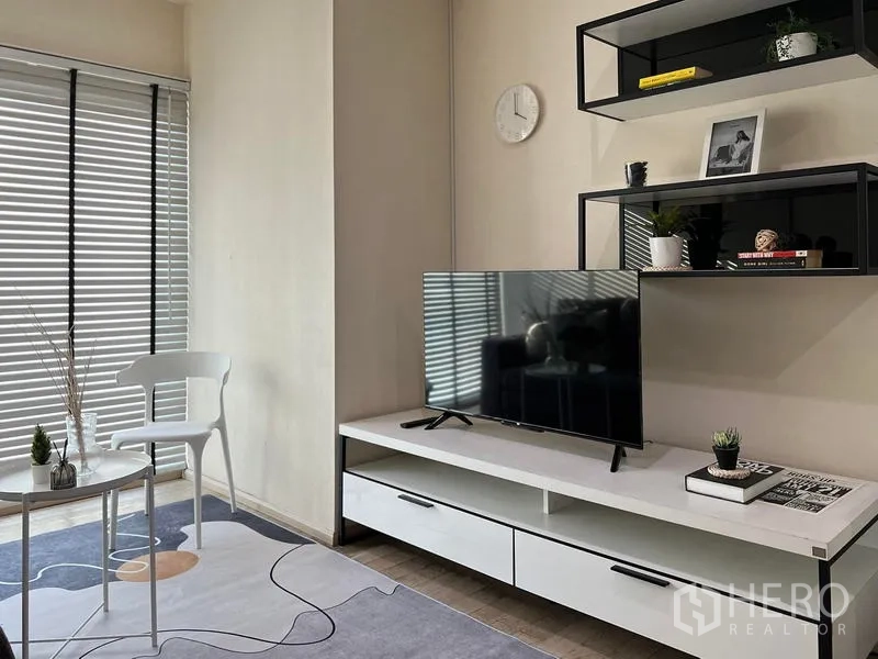Condominium for rent in Khlong Toei, Bangkok - TV console with floating shelves beside a large window with blinds.