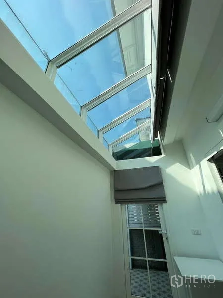 Detached House for rent or sale in Khan Na Yao, Bangkok - Skylight corridor bringing natural light into the rear of the home.