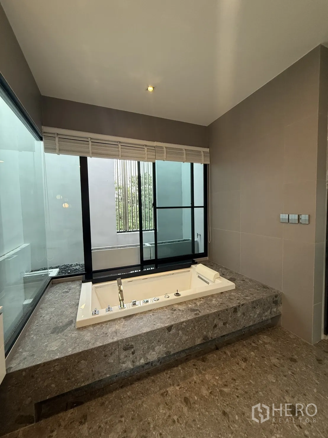 Detached House for rent in Saphan Sung, Bangkok - Modern kitchen with orange cabinetry, black stone countertops and appliances.