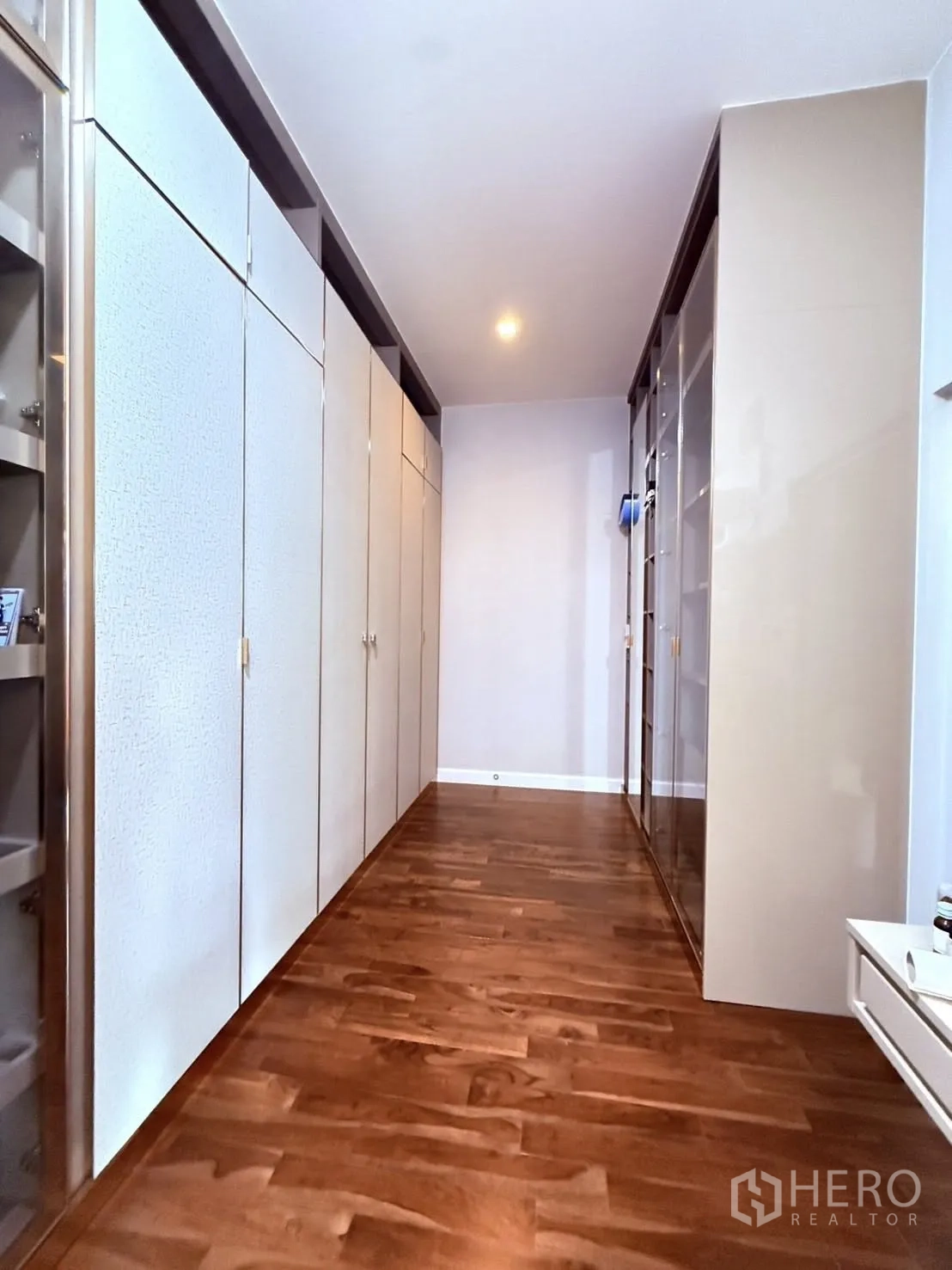 Detached House for rent or sale in Prawet, Bangkok - Walk-in closet corridor lined with full-height wardrobes on both sides.