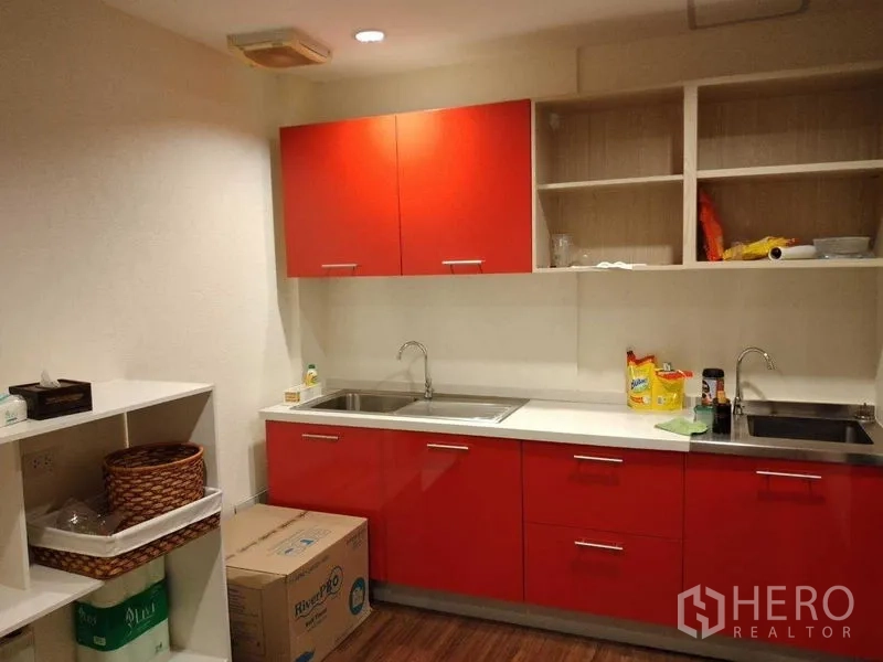 Shophouse for rent in Watthana, Bangkok - Pantry kitchen with bright red cabinets, double sinks, and open shelving.