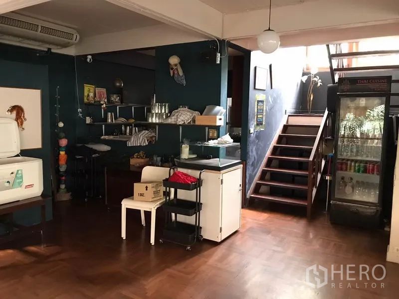 Retail Space for rent in Watthana, Bangkok - Interior bar and shelving area with staircase and drinks fridge.