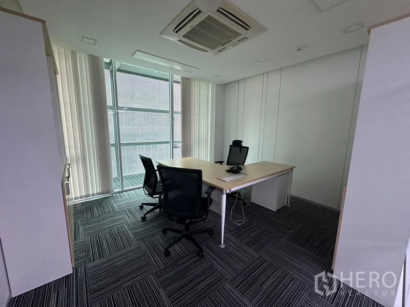 Office Space for rent - Mid-size meeting room with TV at the end wall, glass partition and abundant daylight.