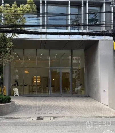 Retail Space for rent in Watthana, Bangkok - Street-facing building exterior with tall glass facade and double-door entrance.