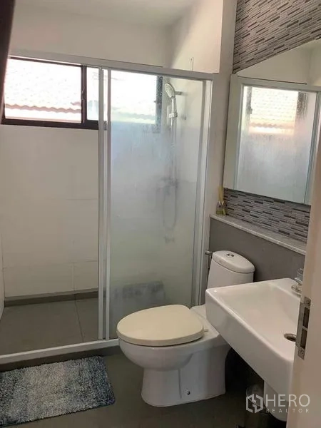 Detached House for rent or sale in Bang Phli, Samut Prakan - Bathroom with glass-enclosed shower, toilet, vanity and window.
