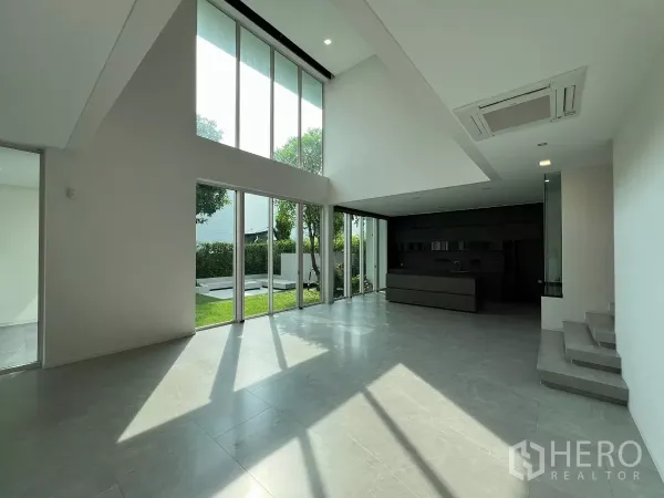Detached House for sale in Bang Phli, Samut Prakan - Double-height living room with floor-to-ceiling windows facing the garden