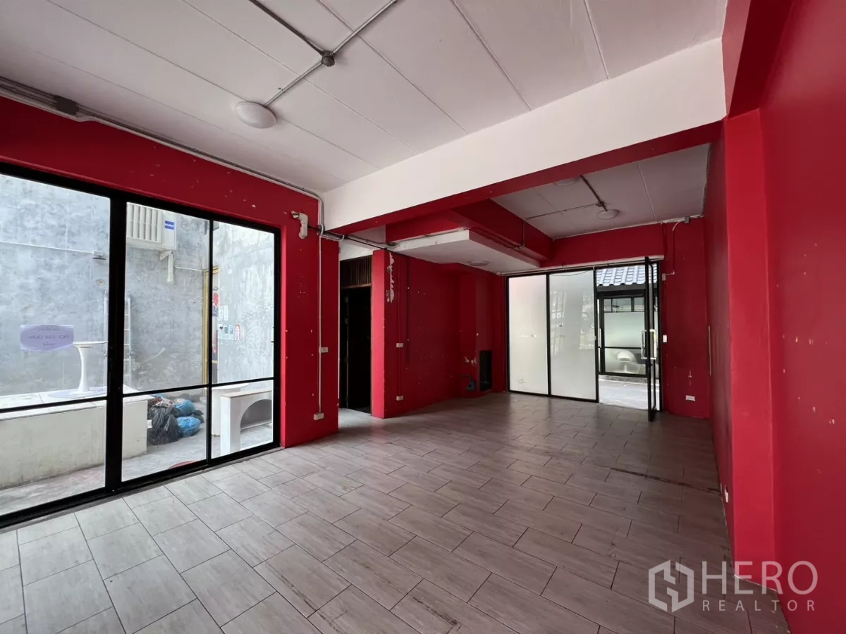Retail Space for rent in Khlong Toei, Bangkok - Open-plan red interior with multiple sliding doors and a side service patio.