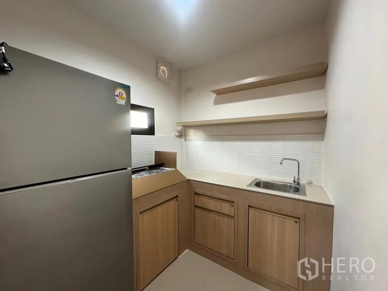Townhouse for rent or sale in Phra Khanong, Bangkok - Front exterior view showing gable roof and two-car carport.