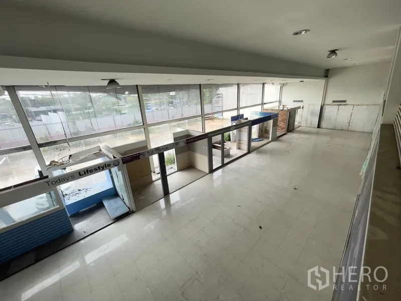 Warehouse for rent in Prawet, Bangkok - Mezzanine level overlooking ground floor through full-height windows.