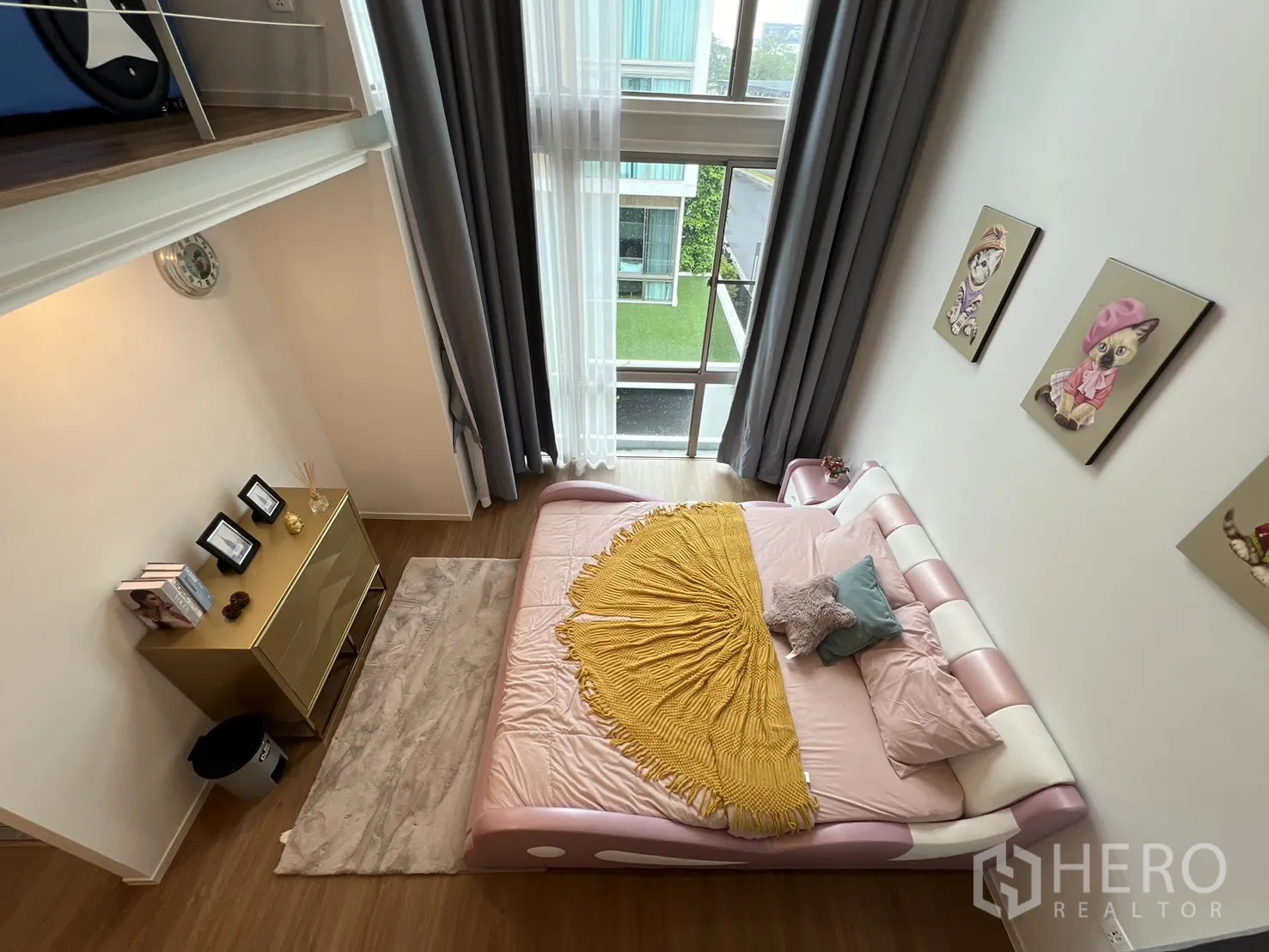 Detached House for rent in Saphan Sung, Bangkok - Mezzanine sleeping area with railing and large windows.