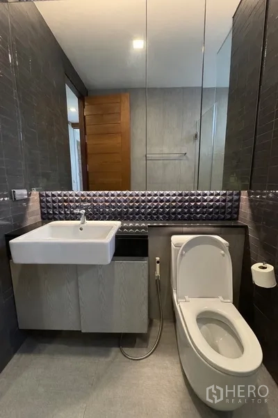 บ้านแฝด for rent in Watthana, Bangkok - ห้องน้ำสไตล์โมเดิร์นพร้อมอ่างล้างหน้าแขวนผนัง โถสุขภัณฑ์ และตู้กระจก