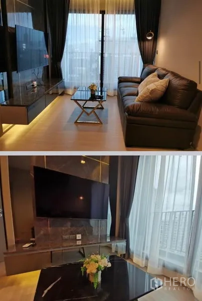 คอนโด ให้เช่าในHuai Khwang, Bangkok - ห้องนั่งเล่นสไตล์โมเดิร์น โซฟาหนัง ผนังทีวี และหน้าต่างเต็มสูงเปิดสู่ระเบียงวิวเมือง
