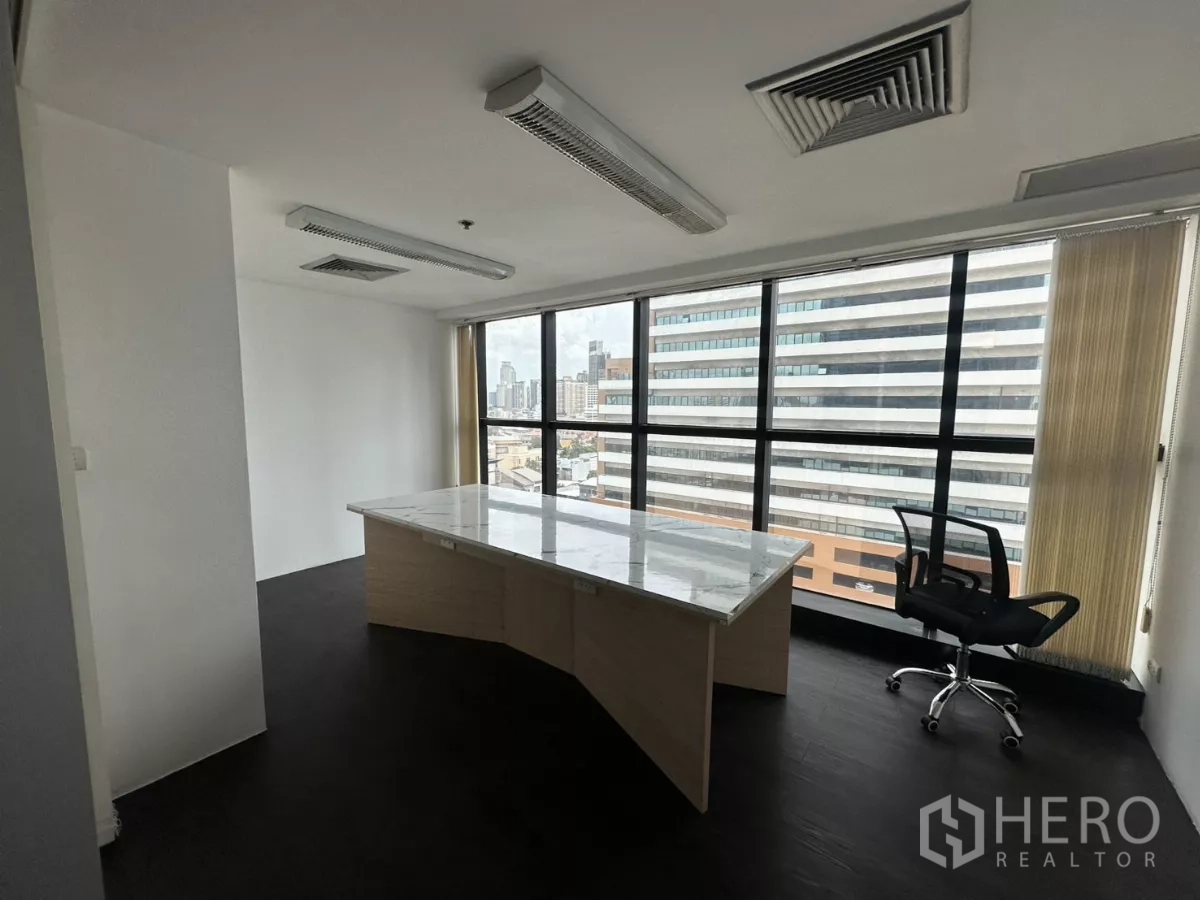 Office Space for rent in Watthana, Bangkok - Private corner office with marble-top desk and floor-to-ceiling windows overlooking the skyline.