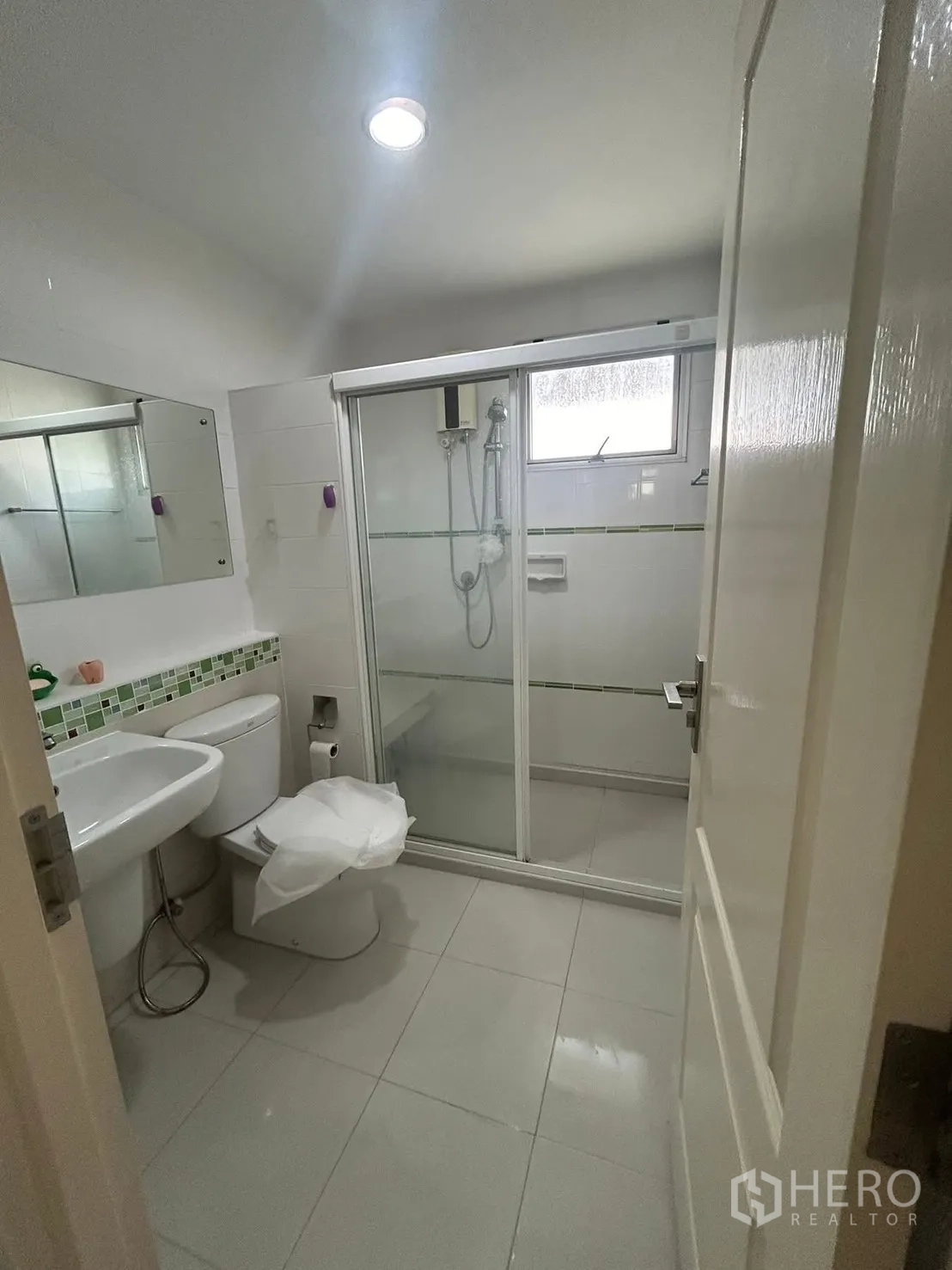 Detached House for rent in Bang Na, Bangkok - Second bathroom featuring glass shower enclosure, toilet, and sink.