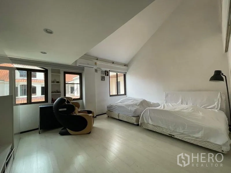 Townhouse for sale - Large vaulted bedroom with twin beds and corner desk by windows.