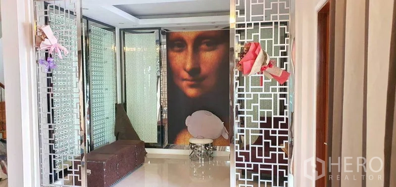 Detached House for sale in Khan Na Yao, Bangkok - Entry hall featuring decorative metal screens and a large classical portrait-style wall mural.