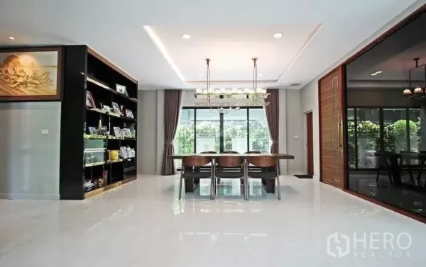 Detached House for rent in Bang Khae, Bangkok - Bright open-plan dining room with large windows, built-in display shelves and garden views.