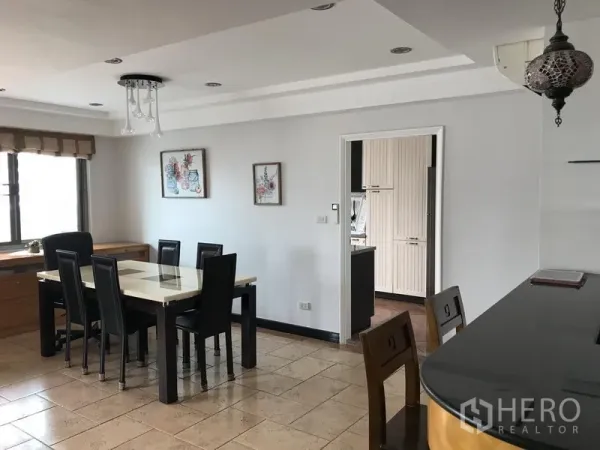 公寓 出租在Watthana, Bangkok - 明亮的用餐区，六人餐桌、瓷砖地面，连通独立厨房，位于Phrom Phong的Royal Castle。