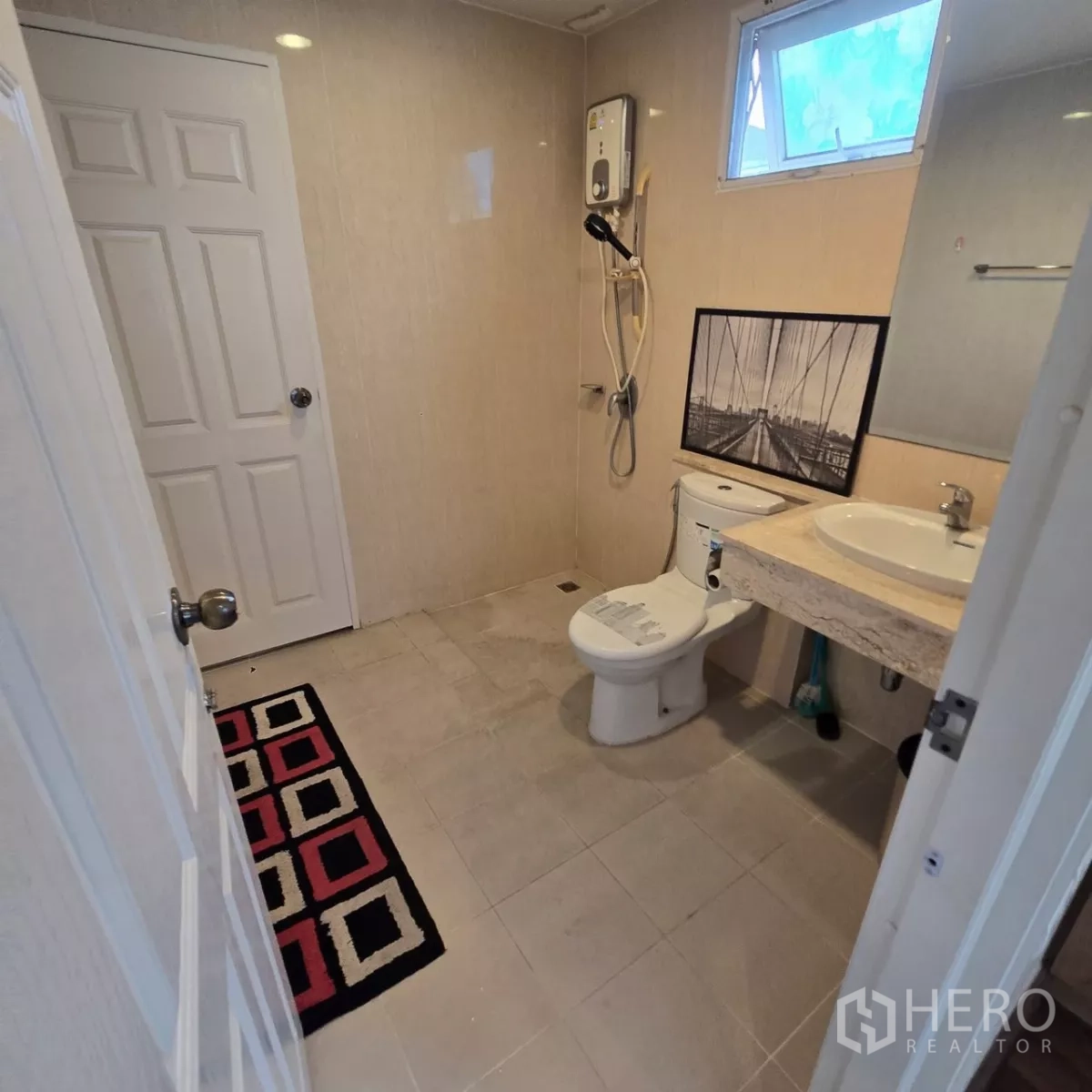 Detached House for rent in Mueang Pathum Thani, Pathum Thani - Bathroom with electric water heater, shower area and vanity.