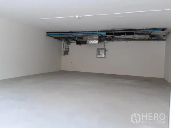 Retail Space for rent in Watthana, Bangkok - Open-plan retail interior with exposed ceiling ducts and polished concrete floor.