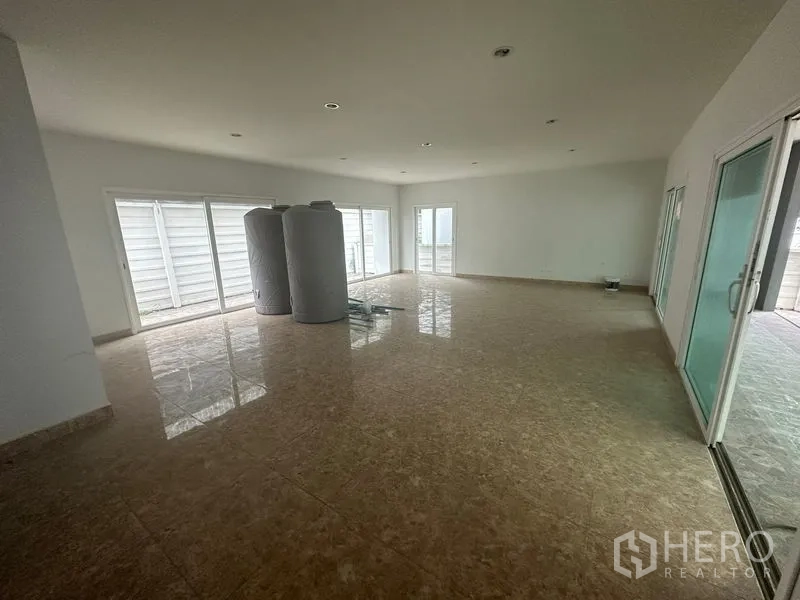 Home Office for rent in Bang Phli, Samut Prakan - Large tiled room with sliding doors opening to side patio.