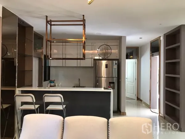 Detached House for rent in Bang Phli, Samut Prakan - Contemporary kitchen with breakfast bar, stools, hanging rack and stainless refrigerator.