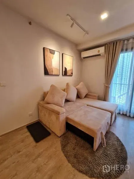 Condominium for rent - Alternate angle of the living room showing sectional sofa and sliding glass to the balcony.