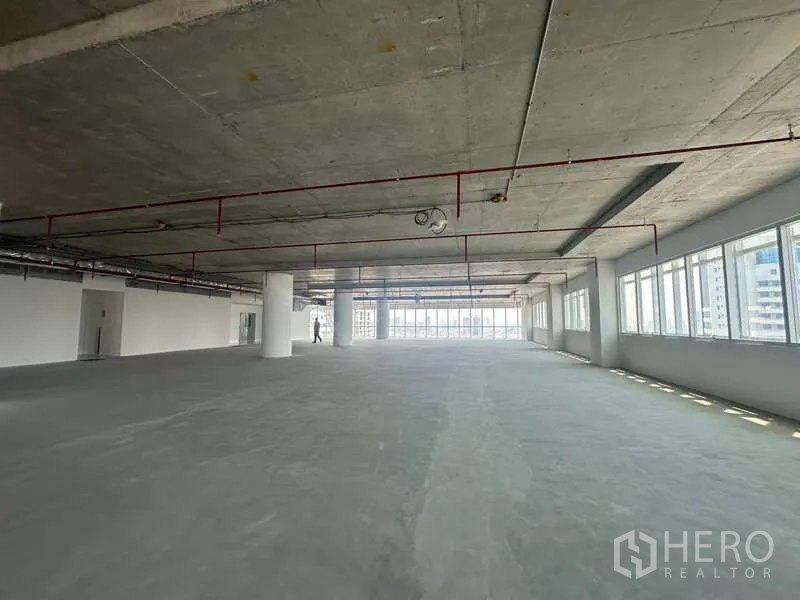 办公空间 出租在Sathon, Bangkok - 曼谷沙吞区大面积毛坯办公室，裸顶、红色喷淋管线与整排采光窗。