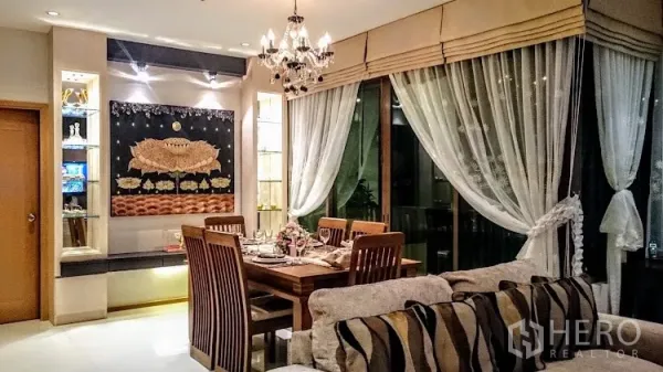 Condominium for rent in Khlong Toei, Bangkok - Elegant dining area with wooden table, chandelier and glass display shelves beside large windows.