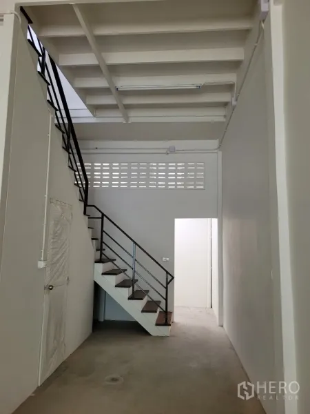 Shophouse for rent in Khlong Toei, Bangkok - Rear section with a metal handrail staircase and doorway providing access to the back area.
