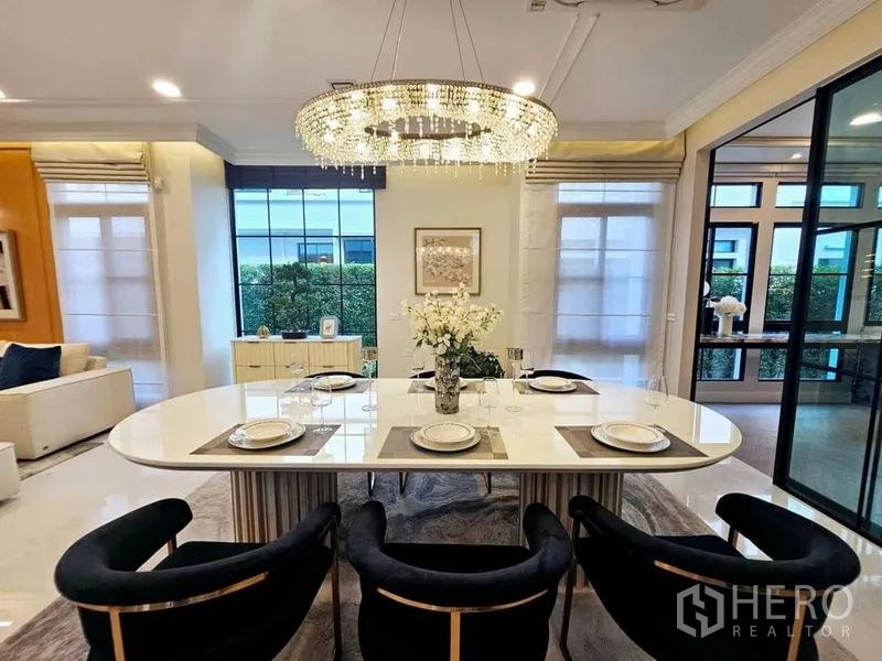 Detached House for rent or sale in Saphan Sung, Bangkok - Elegant dining area set for six beneath a sparkling crystal chandelier.