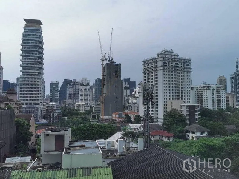 Condominium for rent or sale in Watthana, Bangkok - Bangkok city skyline view from the condominium, with high-rises and greenery.