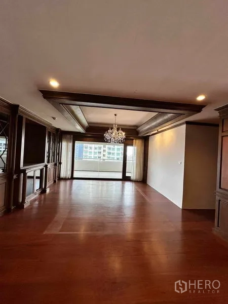 Condominium for rent in Bangkok - Living room framing the balcony and skyline through wide sliding doors.