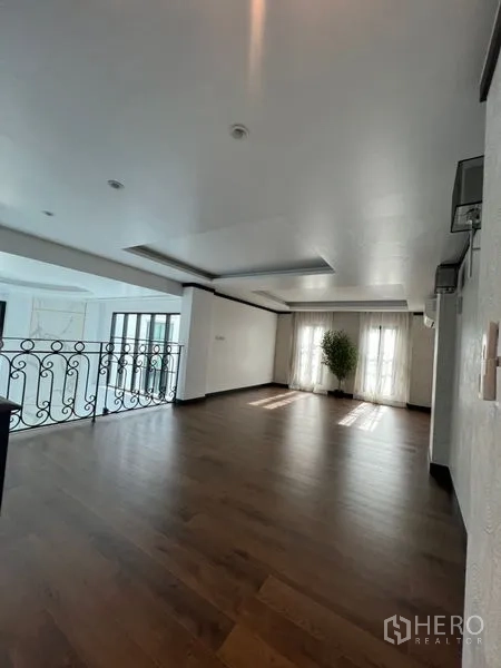 带办公室的家 出租或出售在Watthana, Bangkok - 二层起居空间宽敞，木地板与铁艺栏杆。