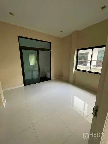 独立式住宅 出售在Lat Krabang, Bangkok - 卧室铺白色地砖，带玻璃门的套内卫浴。