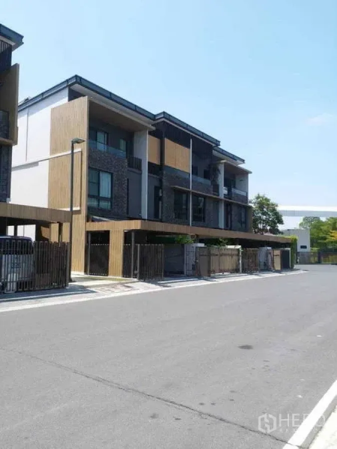 Townhouse for rent - Row of contemporary three-storey townhouses with gated carports on a quiet street.