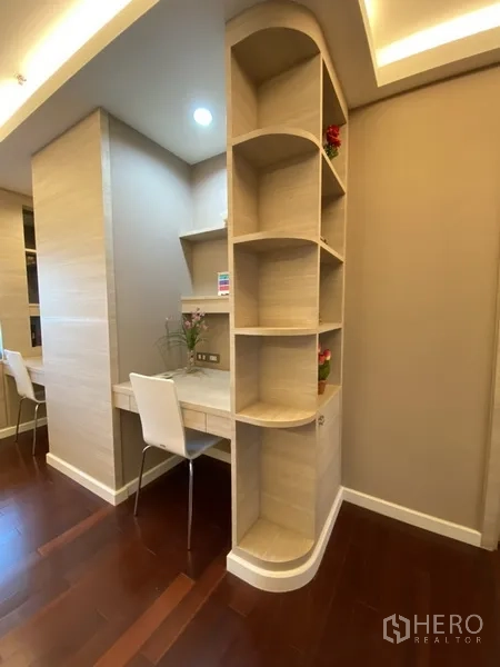 Condominium for rent in Bang Rak, Bangkok - Custom shelving divider with dual study desks and warm ambient lighting.