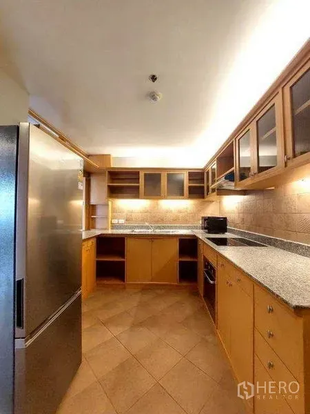 Apartment for rent - U-shaped kitchen with granite countertops, tile backsplash, upper glass cabinets, and a cooktop.