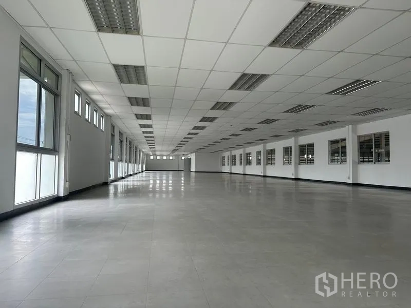 Factory for rent in Pathum Thani - Bright upper-floor office area with tiled floor and ceiling grid.
