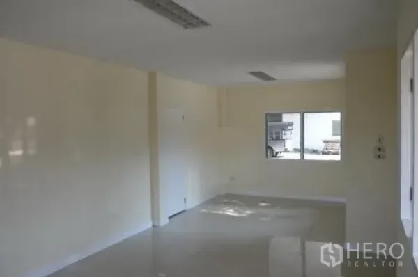 Warehouse for rent in Samut Sakhon - Bright internal office room with a window and tiled flooring inside the warehouse.