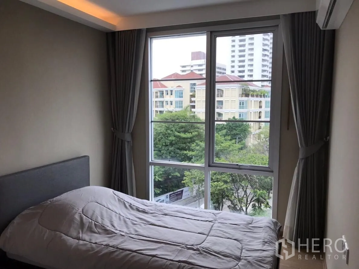 คอนโด ให้เช่าในWatthana, Bangkok - ห้องนอนรับแขก พร้อมหน้าต่างมุมกว้างและวิวอาคารใกล้เคียง
