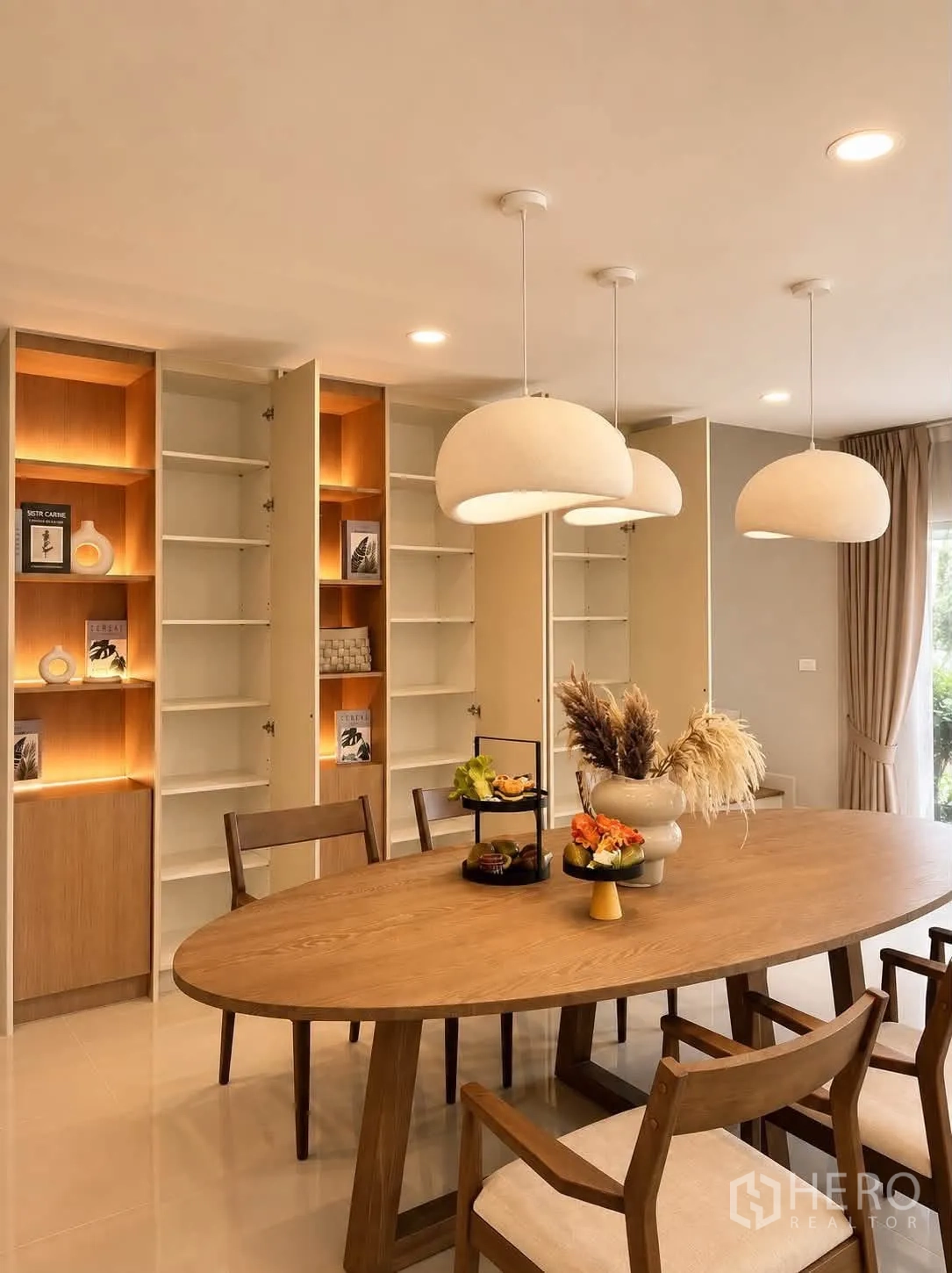 Detached House for rent in Bang Phli, Samut Prakan - Dining area featuring illuminated built-in cabinets and trio of pendant lamps.