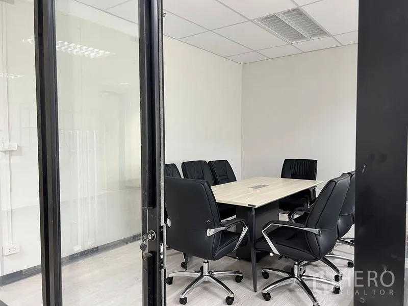 Office Space for rent in Sathon, Bangkok - Small conference room with eight black chairs around a square meeting table.